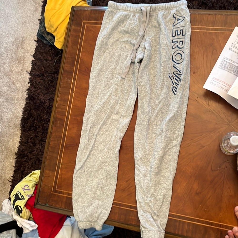 Gray sweatpants with aero Nye written on the side. Scrunch on the end.